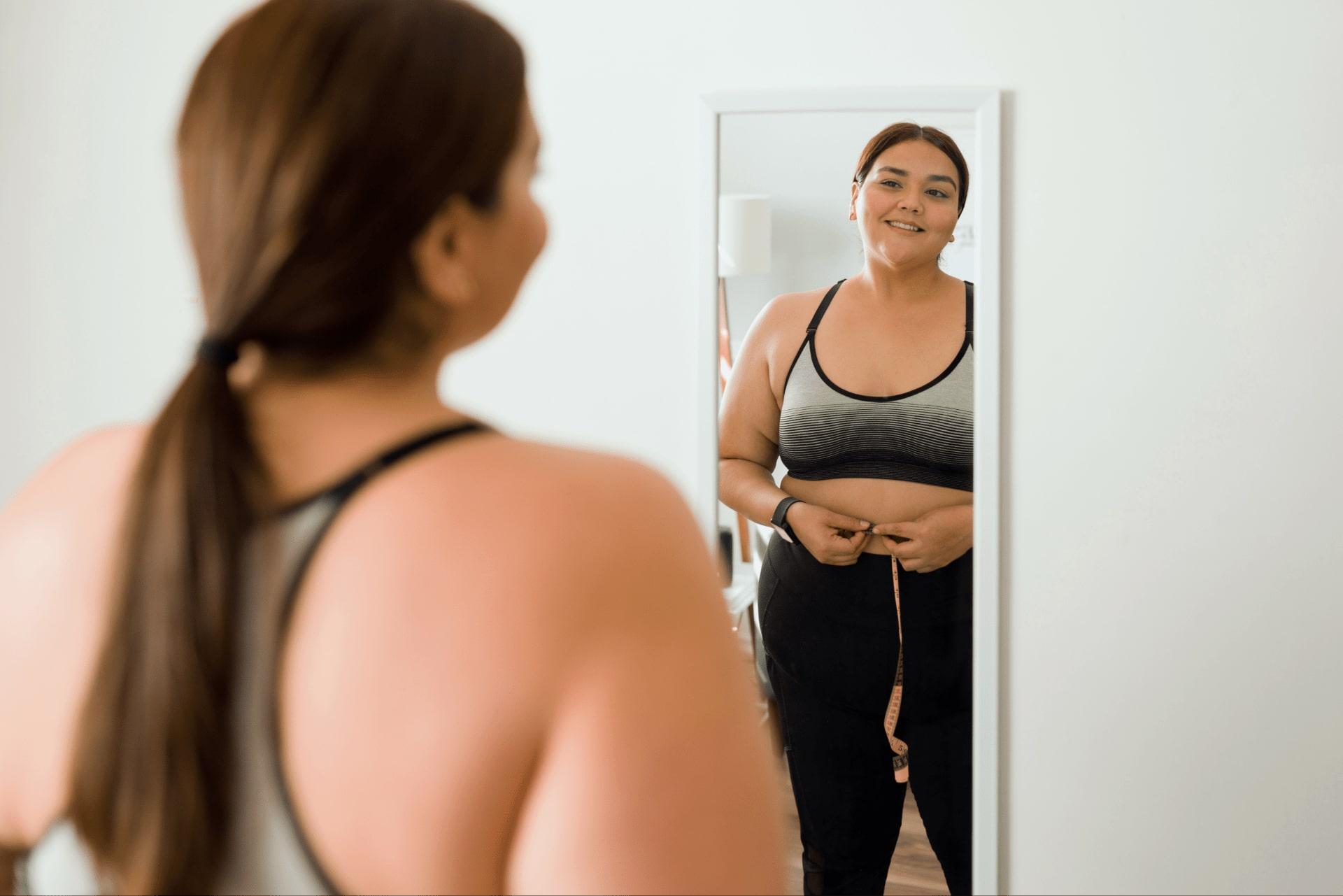 Woman smiling in front of a mirror